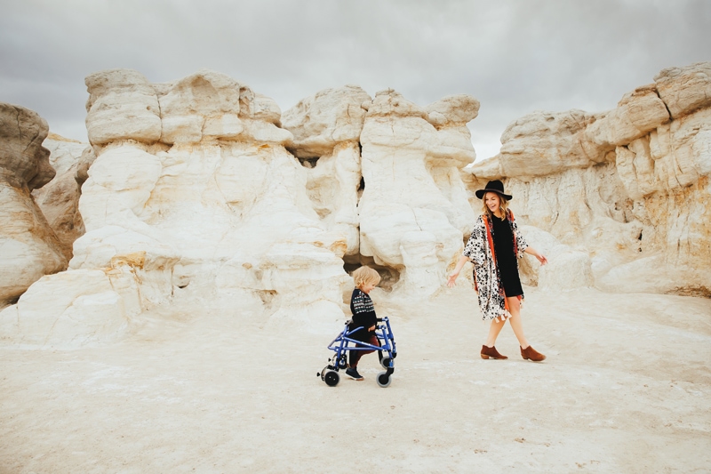 Family Photographer, a mother and her son walk together near sandstone, the boy uses a walker