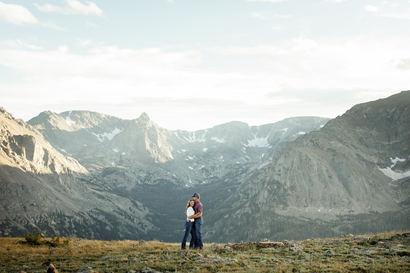 Engagement Photography, Couple hugging with mountains in the background